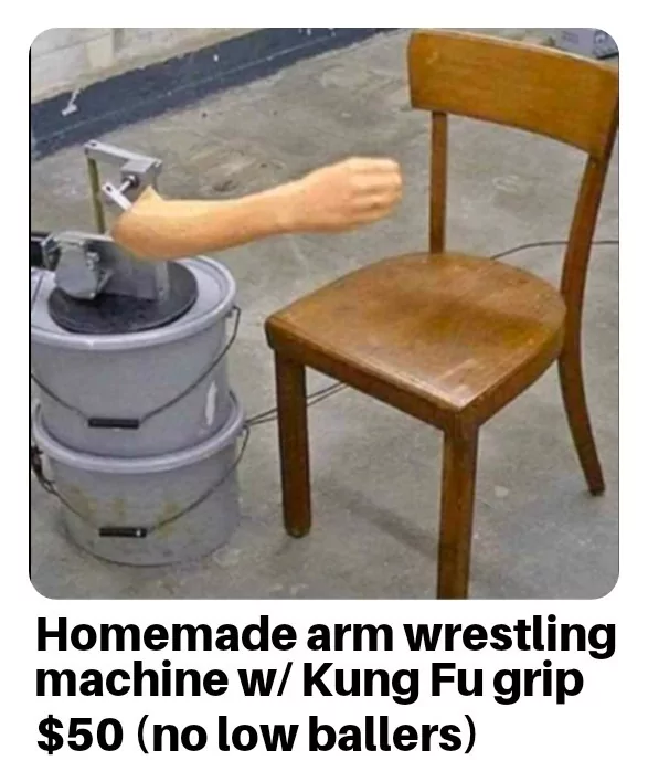 Homemade arm wrestling machine with a fake arm attached to buckets, next to a wooden chair.