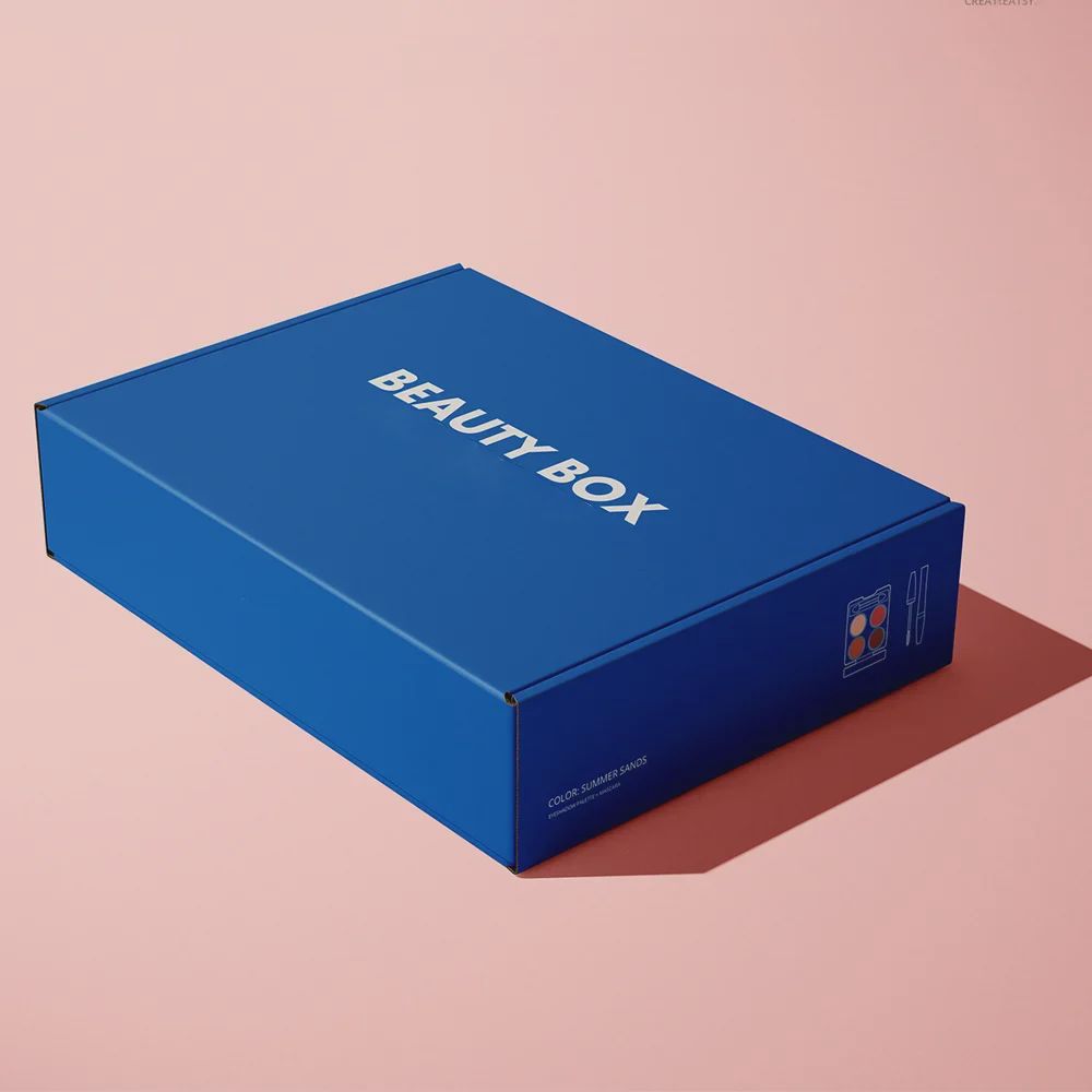 Blue rectangular box labeled BEAUTY BOX with small logo on side against pink background